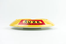 Side-on profile  view of Suze logo on ashtray