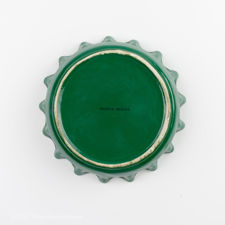 Underside view of green and yellow Perrier bottle cap ashtray 