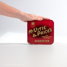 Size demonstration of 1930s McVitie & Price's Digestive Biscuit Tin