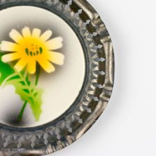 Close up of the rim on a 1920s Metal & Ceramic Yellow Flower Coaster