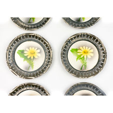 Close up of the middle two 1920s Metal & Ceramic Yellow Flower Coasters