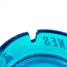 Close up number 1 of a fault on the blue glass Gitanes ashtray