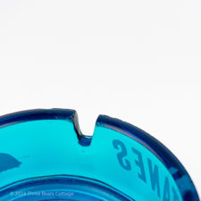 Close up number 2 of a fault on the blue glass Gitanes ashtray