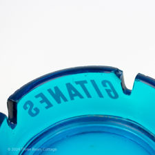 Close up number 3 of a fault on the blue glass Gitanes ashtray