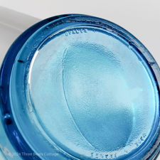 Close up of the Opalex maker's mark on a blue glass Gitanes ashtray