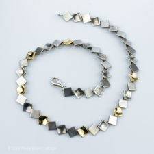 Zoomed out view of a vintage Silver, Brushed Silver & Gold Vermeil Square Necklace