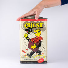 Size demonstration of a large retail Chest brand cough sweets tin