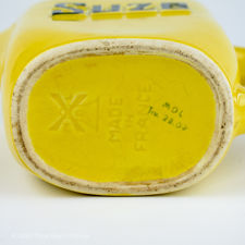 Underside view and maker's mark of a Yellow Moulin des Loups Suze Jug